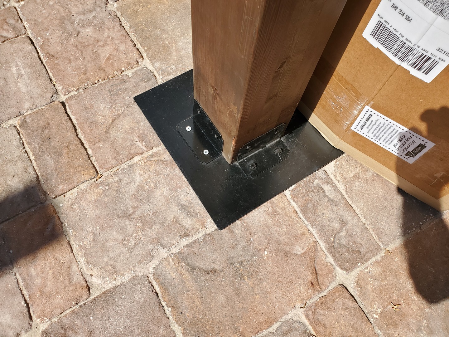Post to flat plate over paver stones with deck foot anchor.