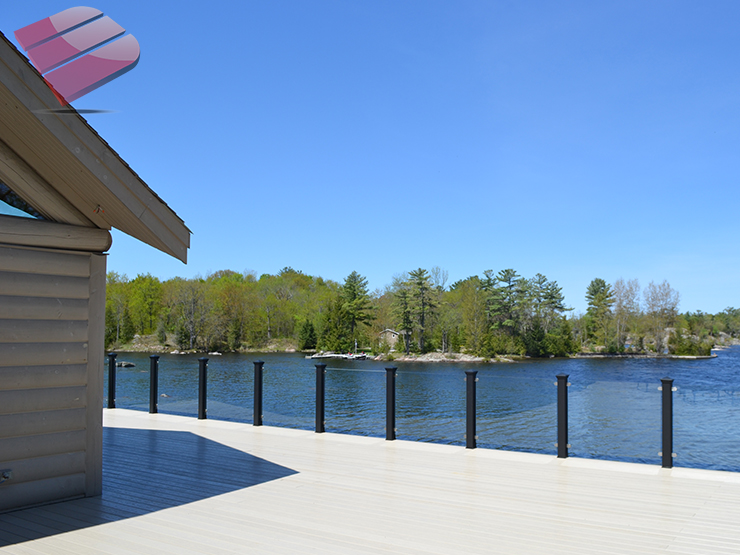 This outdoor deck blends into its forest setting, looking like it naturally belongs. The dark earthy tones of the wood complements the trees and surrounding nature.