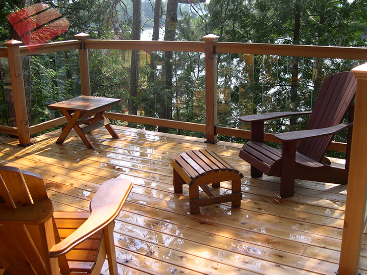 One With Nature This outdoor deck blends into its forest setting, looking like it naturally belongs. The dark earthy tones of the wood complements the trees and surrounding nature.