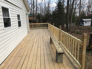 The new added deck runs along the entire side of the house and wraps around the back side also. Renovated deck running on side of house.