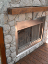 Stainless steel fireplace appliance and wood mantel piece