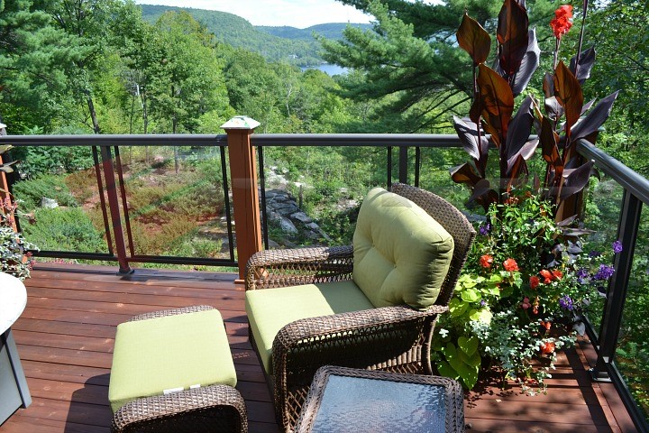 Deck with a Beautiful Mountain View Nothing is better than a beautiful deck paired with a breathtaking view. This deck features just that: A magnificent view of the foliage and greenery of the mountain side.