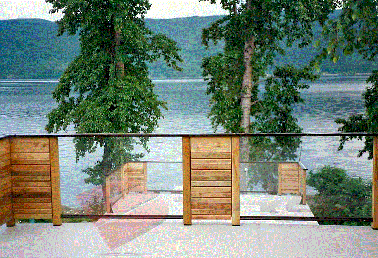 Deck with a Clear Lake View This image features wood and glass paneling used to highlight a gorgeous water view.