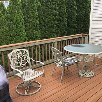 Old wood deck with railing and chairs