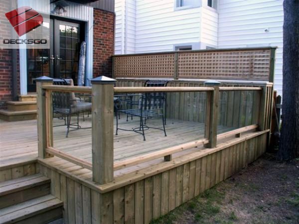Treated wood deck with glass rails.