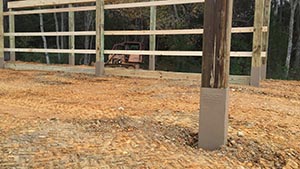 This support post will never rot and this barn will stand for a hundred years or more now A protected wood support post