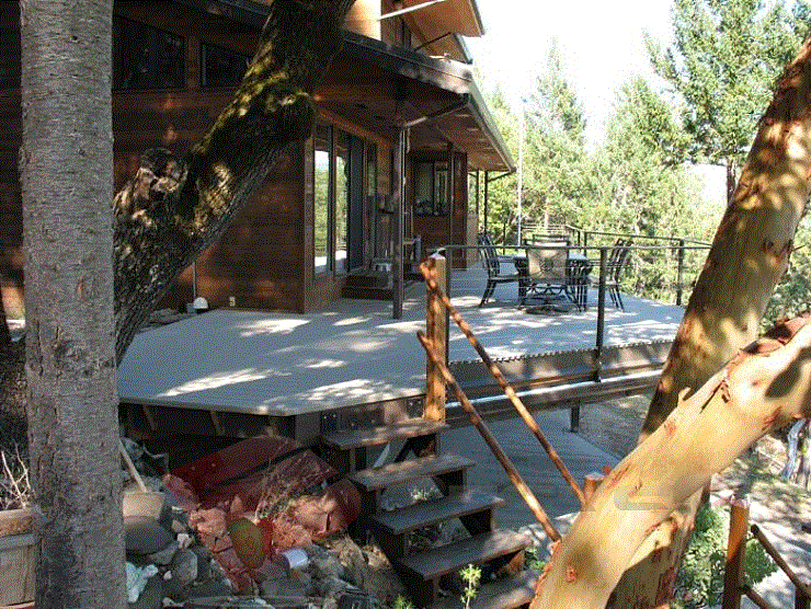 This walk-out deck features rustic looking stairs, aluminum decking, and cable wire railings. The cable wire allows for an open view. And wow, the view is breathtaking.