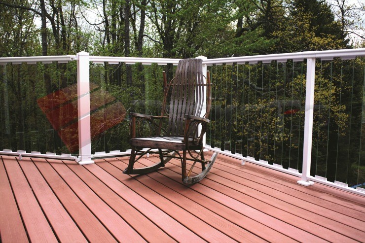 White Aluminum Railing System with Glass Balusters White aluminum railing posts complemented by glass balusters create and open and airy view off of the deck.