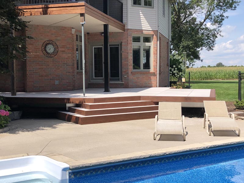 Tropical hardwood fascia and picture framing over stone infill deck.