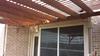 Another vlose view of pergola roof against house