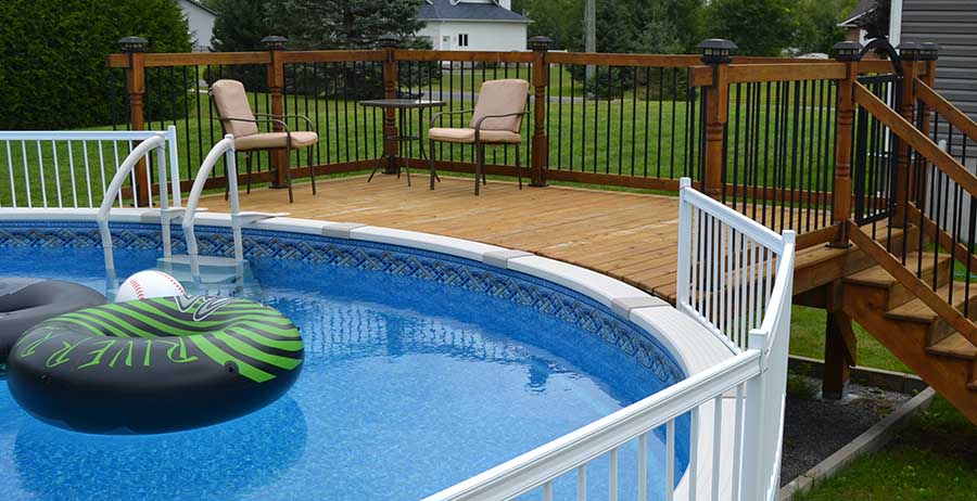 Beautiful treated wood above ground pool deck built using the Titan Deck Fo...